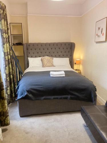 a bedroom with a large bed with a black blanket at Mulgrave Lodge in Dun Laoghaire