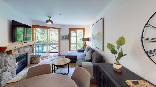 a living room filled with furniture and a window at Lost Lake Lodge by Whistler Premier in Whistler
