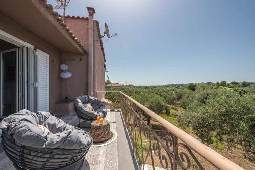 a balcony with two chairs and a table on a balcony at Castle's Nest 1 in Kástro Tornéze