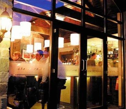 a group of people sitting at a counter in a restaurant at Trout Hotel in Cockermouth