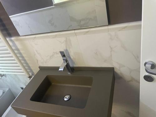 a bathroom with a sink in a room at Palazzo Sarti Suites in Rodi Garganico