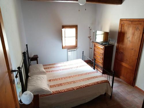 Ένα ή περισσότερα κρεβάτια σε δωμάτιο στο Podere I Laghi