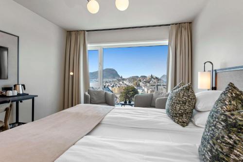 a bedroom with a large bed with a large window at Scandic Parken in Ålesund