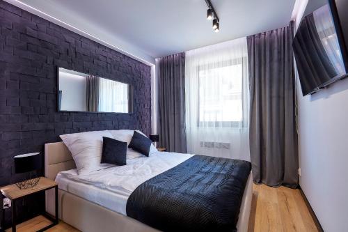 1 dormitorio con cama y pared de ladrillo en Apartament Pieniny en Jaworki
