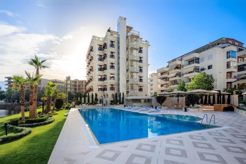 een hotel met een zwembad voor een gebouw bij Radisson Collection Morina Hotel, Tirana in Tirana