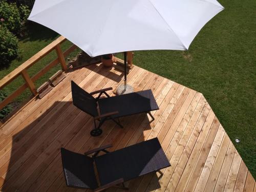 an overhead view of two chairs and an umbrella on a deck at RELAXX Home in Woryty