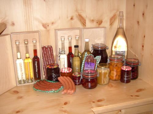 a shelf with a bunch of bottles and jars on it at Untersteinhof in Forstau