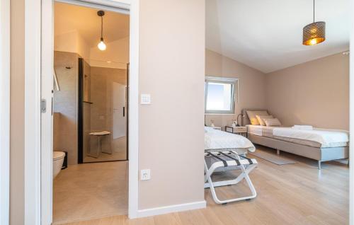 a bedroom with a bed and a bathroom at 3 Bedroom Nice Home In Zman in Žman