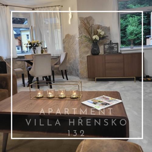 a living room with a table with candles on it at Apartment Villa Hřensko 132 in Hřensko