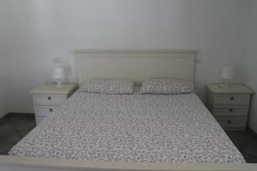 a bedroom with a bed with two nightstands at Antica Dimora Italiana in Fabriano