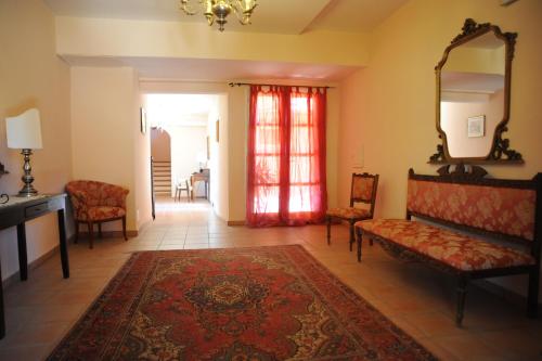 a living room with a couch and chairs and a mirror at Hotel Residence Villa San Giovanni in Portoferraio