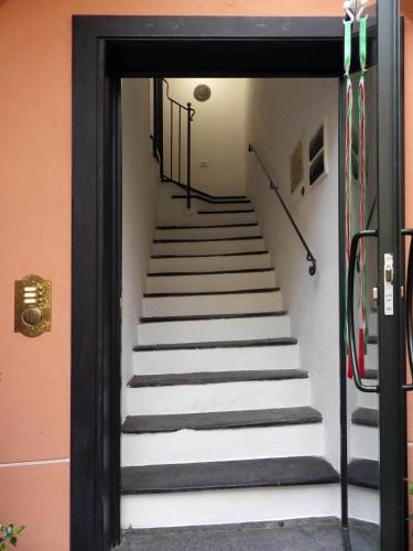 a stairway leading up to a set of stairs at La dimora del Conte Bracco B. in Albenga