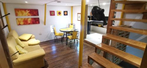 a living room with a couch and a table at Parrot House San Antonio in Cali
