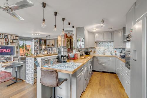 a kitchen with white cabinets and a counter top at Luxe Penthouse with Rooftop Garden & Views in Norwich