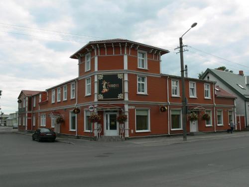 a large red building on the corner of a street at Villa Eeden in Pärnu