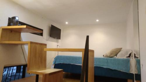 a bedroom with a bunk bed with a blue bed at Parrot House San Antonio in Cali