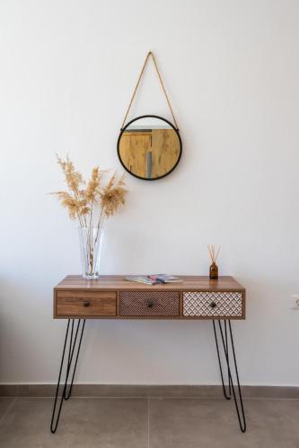a dressing table with a mirror on a wall at Aronia Luxury Apartments Karpathos in Karpathos Town
