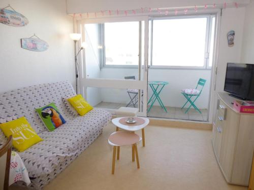 un petit salon avec un canapé et une table dans l'établissement Appartement familial avec balcon, à 50m de la plage – 2 pièces, 4 couchages, WiFi et parking gratuits - FR-1-224C-153, à Saint-Hilaire-de-Riez