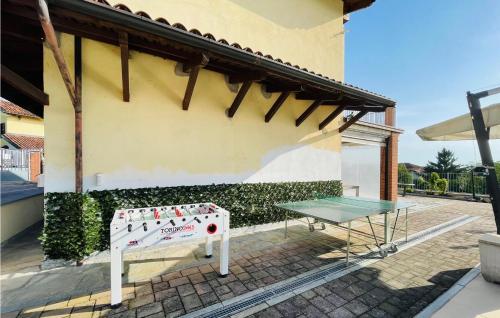 a ping pong table next to a building at Amazing Home In Montegrosso Cinaglio in Monale