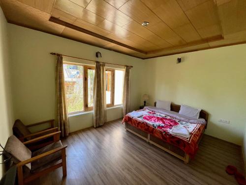 a bedroom with a bed and a large window at Niri-la Guest house Leh in Leh