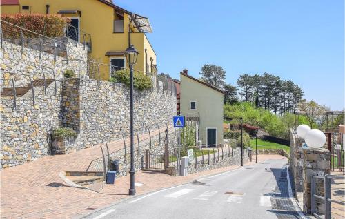 an empty street next to a stone wall at Amazing Home In Magliolo With Sauna in Magliolo
