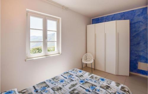 a bedroom with a bed and a window at Amazing Home In Magliolo With Sauna in Magliolo
