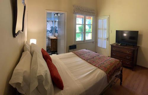 a bedroom with a bed with a television and a dresser at Las Rucas in San Martín de los Andes