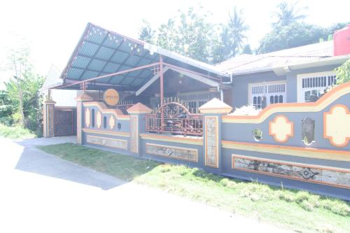 a train station with a train on the side of it at Penginapan Bunga Sonsang Padang Syariah in Tabing