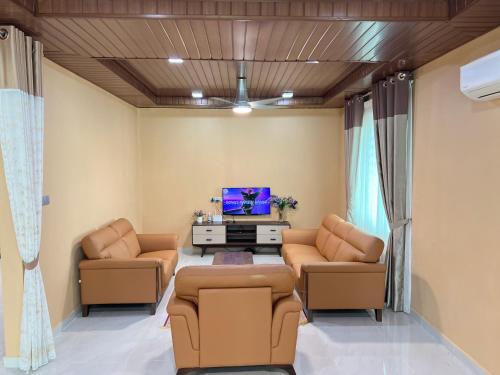a living room with two couches and a tv at BUNGALOW D'CENANG- Private Pool in Pantai Cenang
