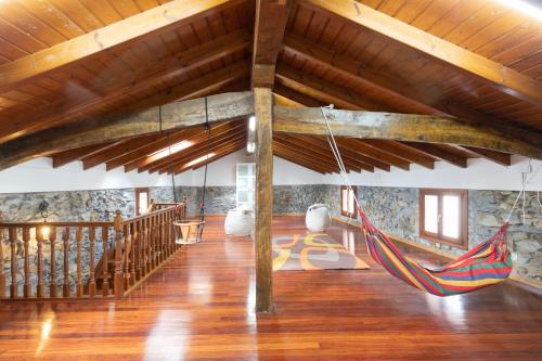 a room with a hammock hanging from a wooden ceiling at Erribera - baskeyrentals in Berriatúa
