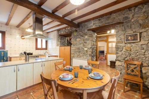 a kitchen and dining room with a wooden table at Erribera - baskeyrentals in Berriatúa