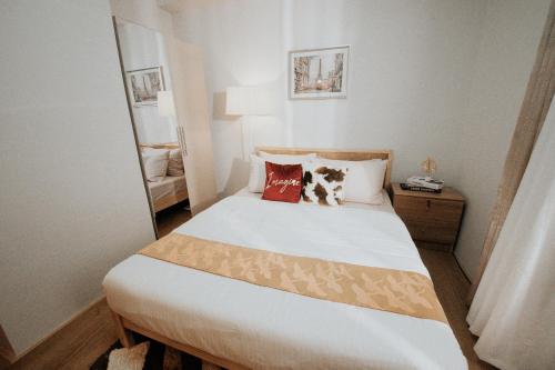 a bedroom with a large bed with two pillows at LFCM Condo Home @ Mesatierra Residences Davao City in Davao City