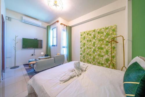 a bedroom with a bed and a couch and a television at 3Kiss Homestay in Wujie
