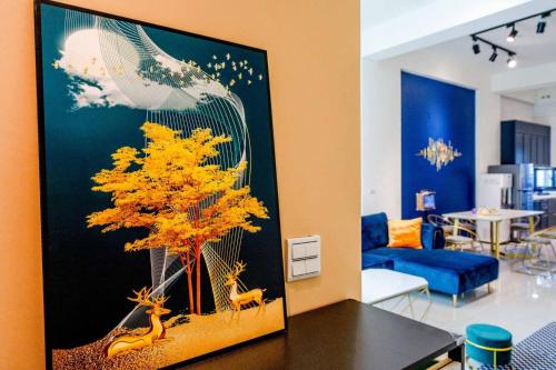 a painting of a tree in a living room at 3Kiss Homestay in Wujie