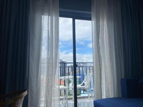 a room with a window with a view of a balcony at Junlan Hotel in Sihanoukville