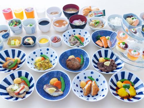 a table with plates of food on it at Hotel Cuore Nagasaki Ekimae in Nagasaki