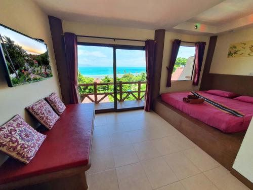 a room with two beds and a view of the ocean at Moonstone Studio in Haad Rin