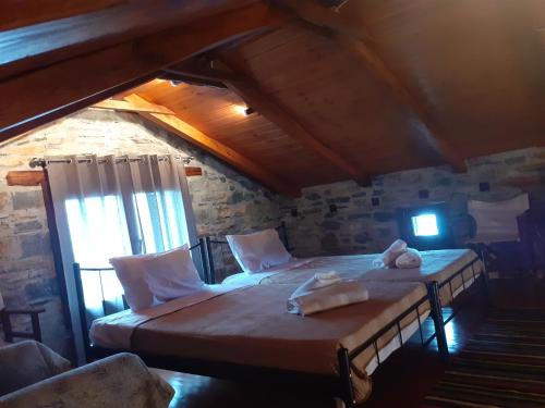a bedroom with two beds in a attic at LIMNIONAS SUNVIEW in Xorychti