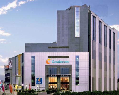 a building with a sign on the front of it at Comfort Inn Tulip Heights in Bathinda
