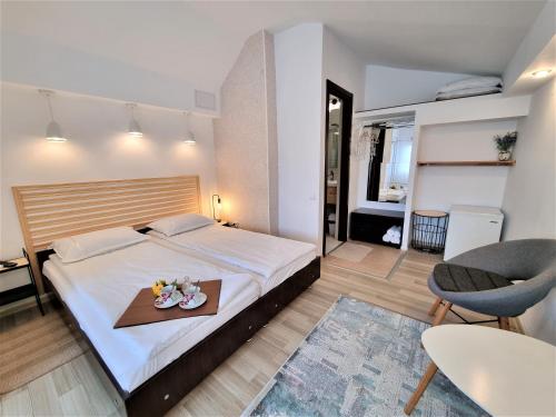 a bedroom with a bed and a table with a tray at Casa Eladi in Eforie Sud