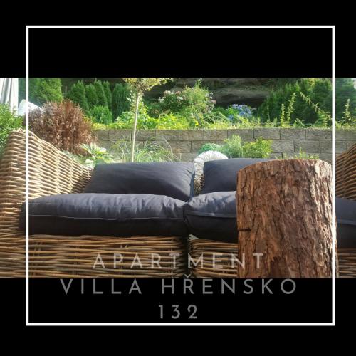 a couch sitting on top of a wooden table at Apartment Villa Hřensko 132 in Hřensko