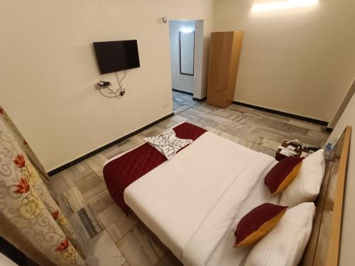 a bedroom with a large bed and a television at GT Grande Hotel-Near US Consulate in Chennai