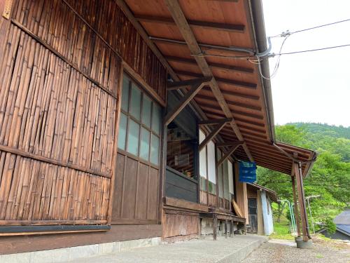 a large wooden building with windows on the side of it at Guesthouse boro-ya in Otoyocho