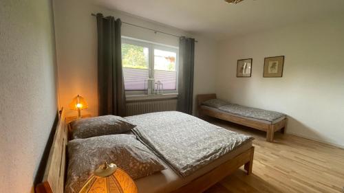 a bedroom with a bed and a window at Fischers Nordseehaus Bungalow mit Garten in Wilhelmshaven