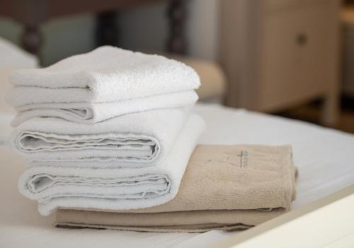 a pile of towels sitting on a table at Ammouda Villas in Ormos Panagias