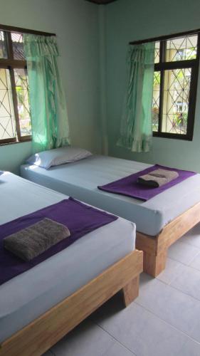 A bed or beds in a room at Charung Bungalows