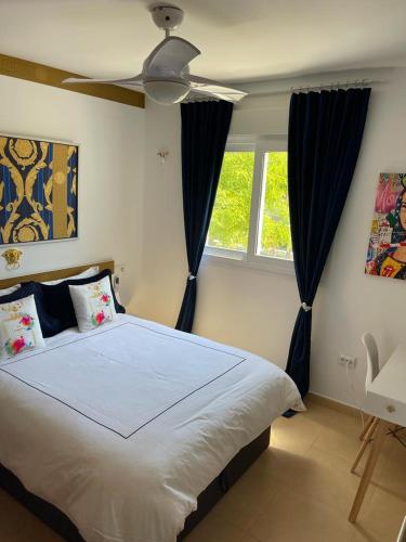a bedroom with a large bed with a ceiling fan at Casa Beau Murcia, Condado de Alhama in El Romero