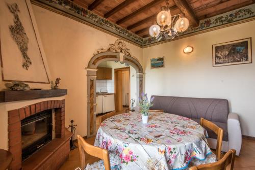 a dining room with a table and a fireplace at Casa Vacanze del Borgo in Montalcino