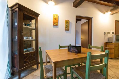 a dining room with a wooden table and chairs at Cà Borgo Vecchio in Brusasco