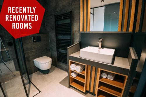 a bathroom with a white sink and a toilet at Guest House Pohorska Kavarna in Maribor